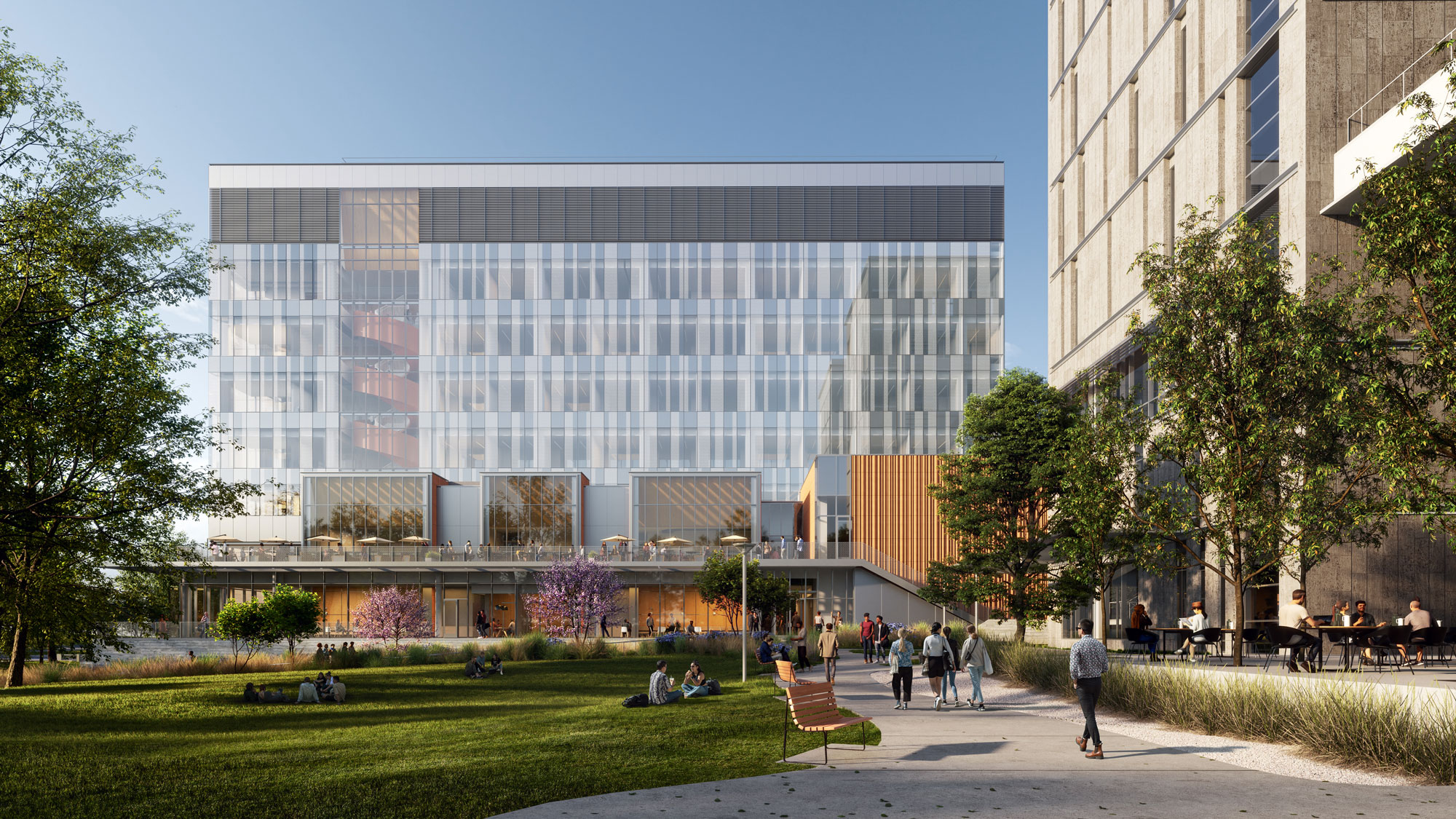 Engineering building with expansive windows, lawn and trees at the UT Austin campus