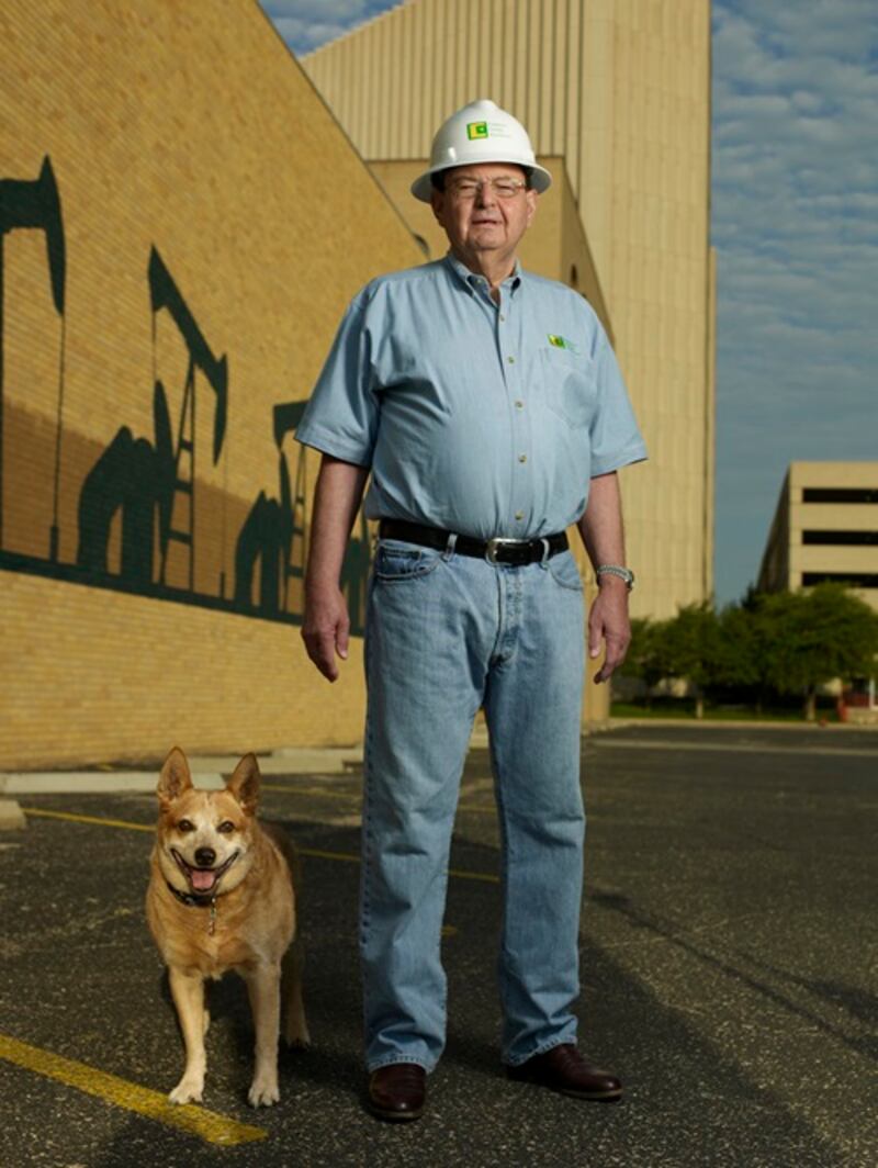 Autry Stephens stands in front of a building with his dog