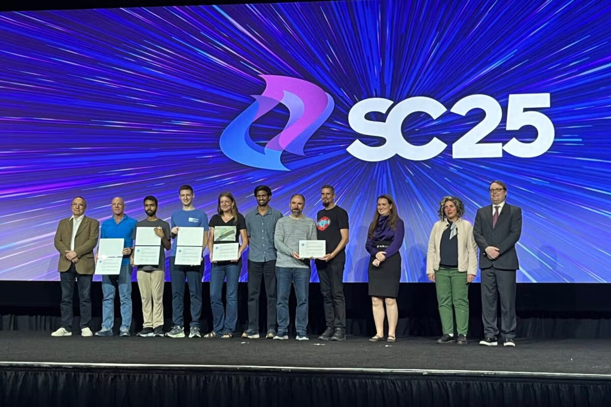 Texas Engineer Omar Ghattas and research team standing on stage with award at SC 25 event