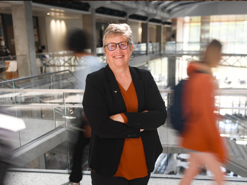 Michele Meyer smiling in EER while students walk by