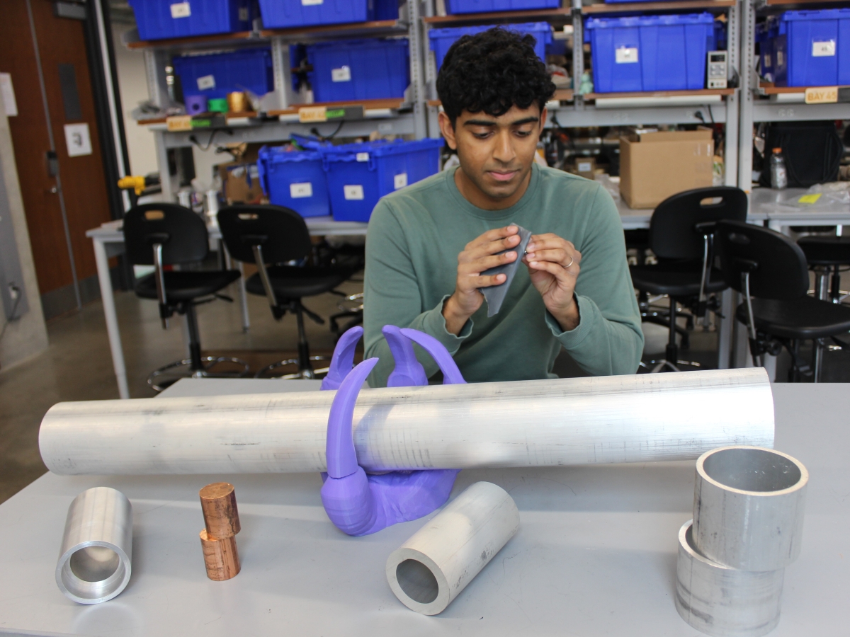 Texas Inventionworks staffer Adarsh Pulasseri works on his rocket project.