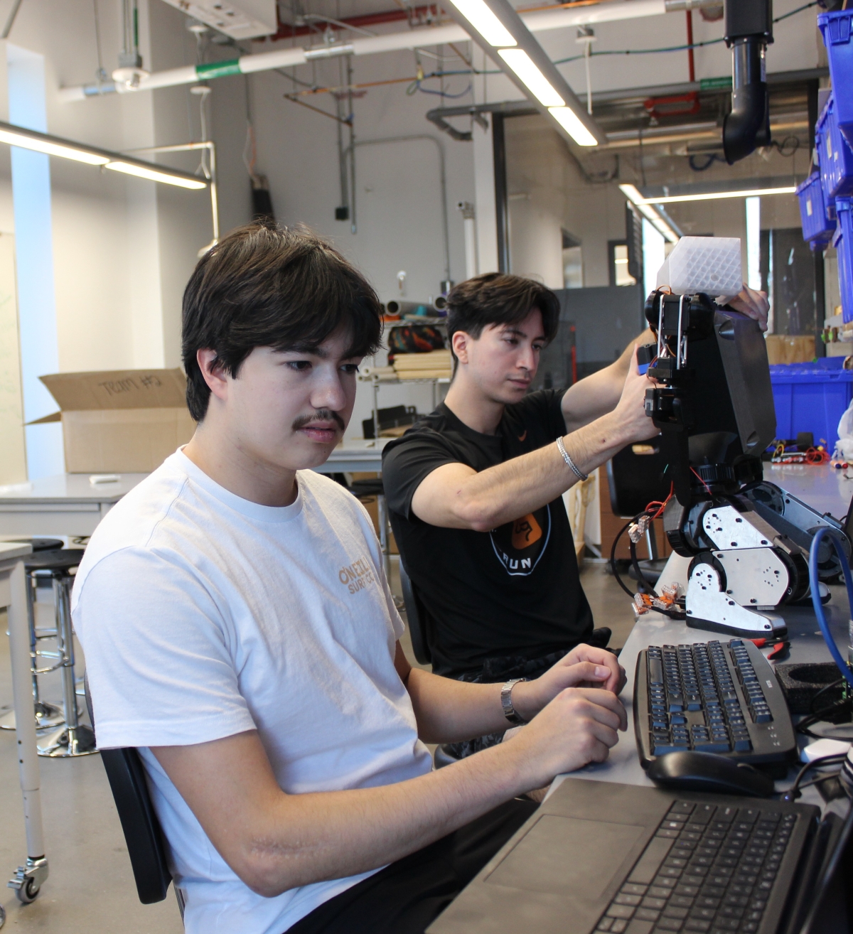 Texas Inventionworks staffer Seth Friend working on his robot.