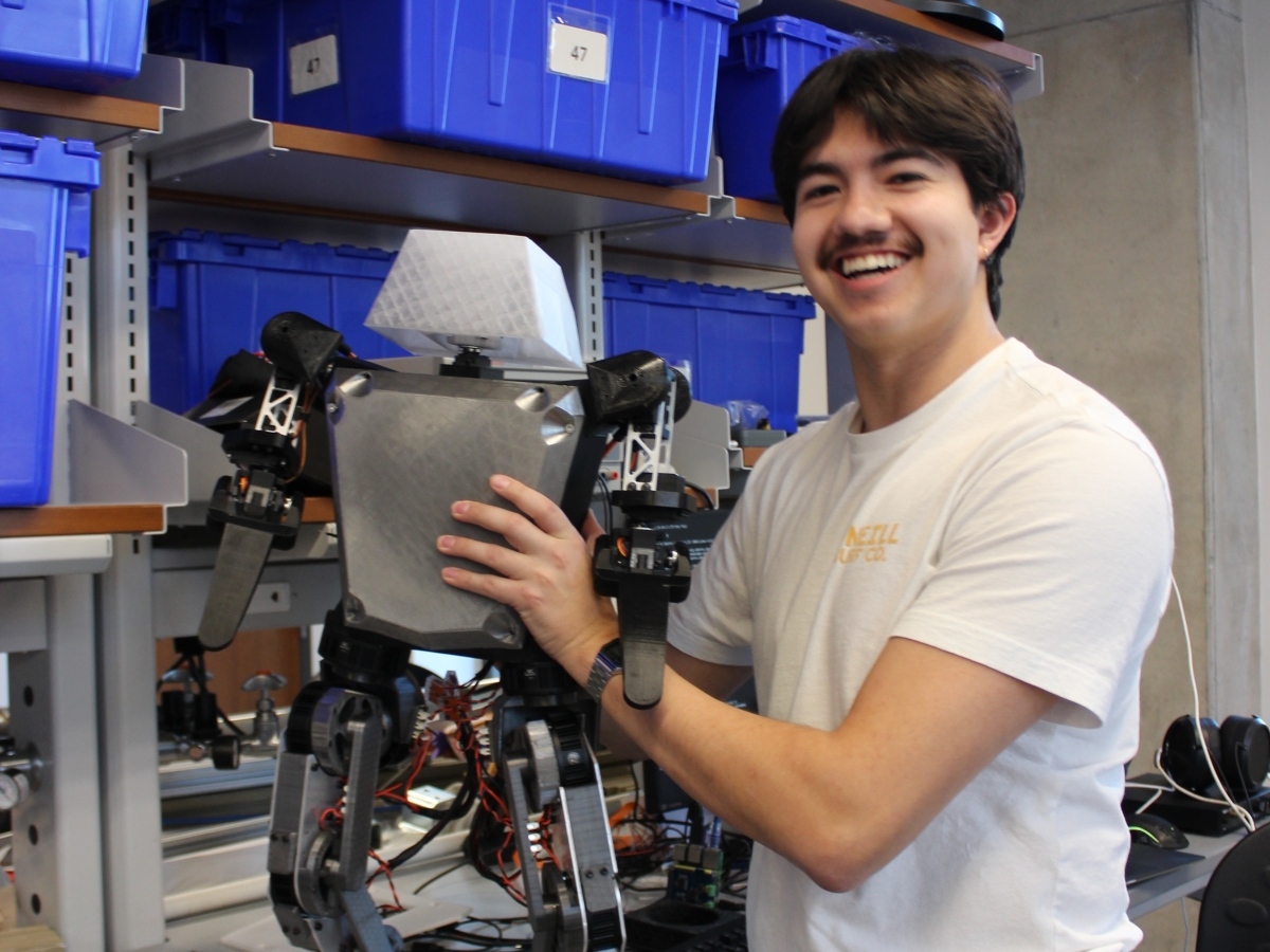 Texas Inventionworks staffer Seth Friend with the humanoid robot he is working on.