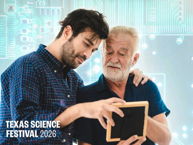 Two men looking at small photo frame together