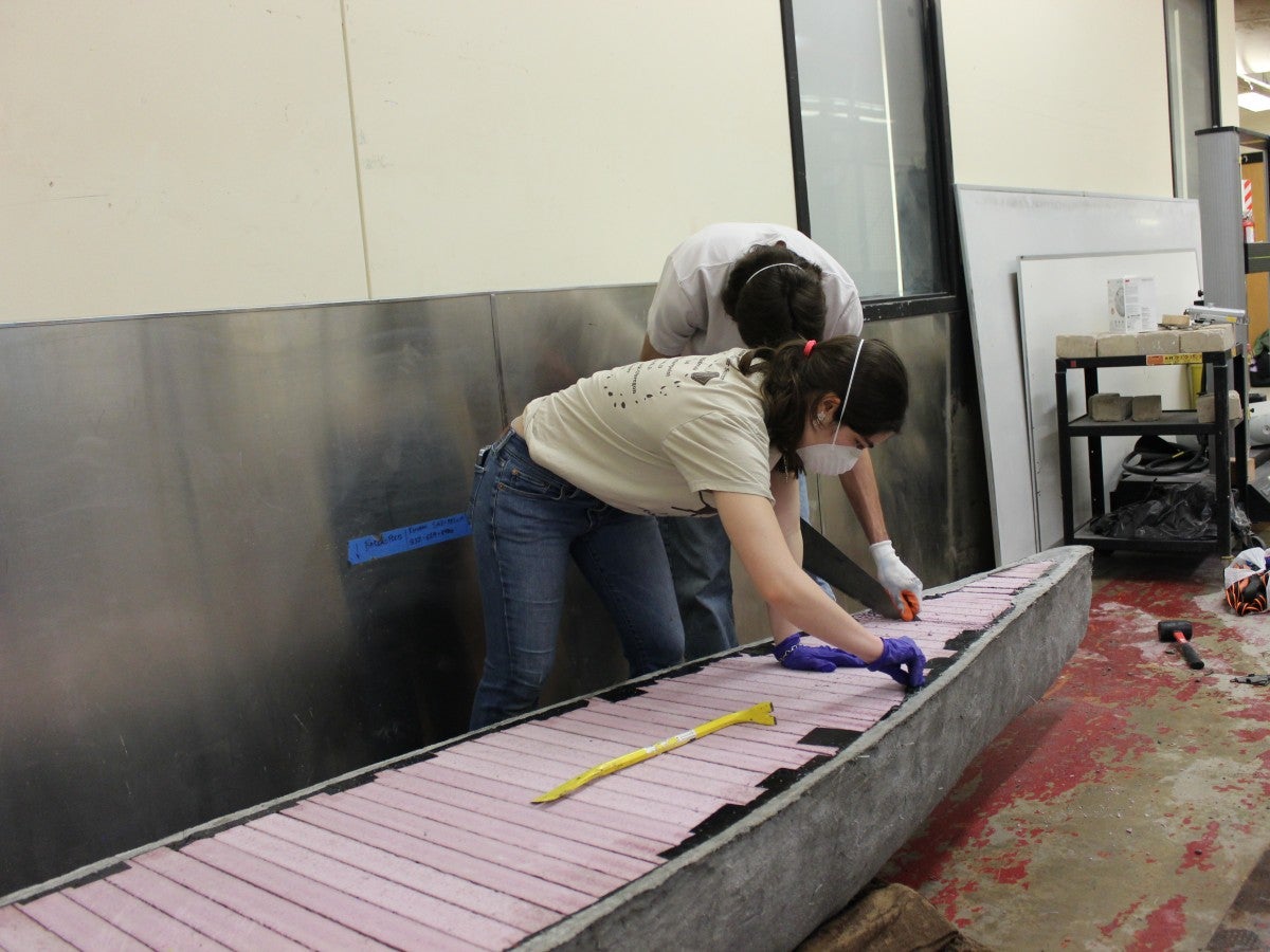 Concrete Canoe team members work on their boat.