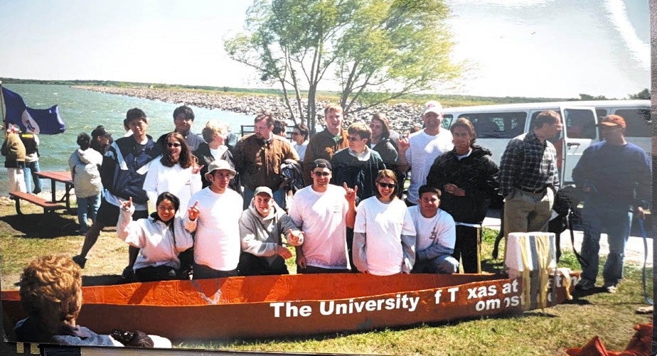 A past Concrete Canoe team poses with their boat.