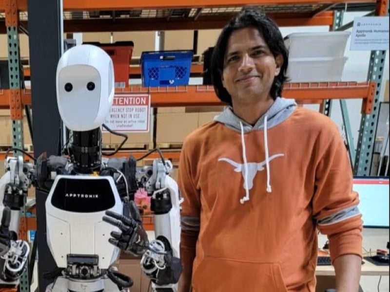Texas Engineering alumnus Deepu Talla with a robot.