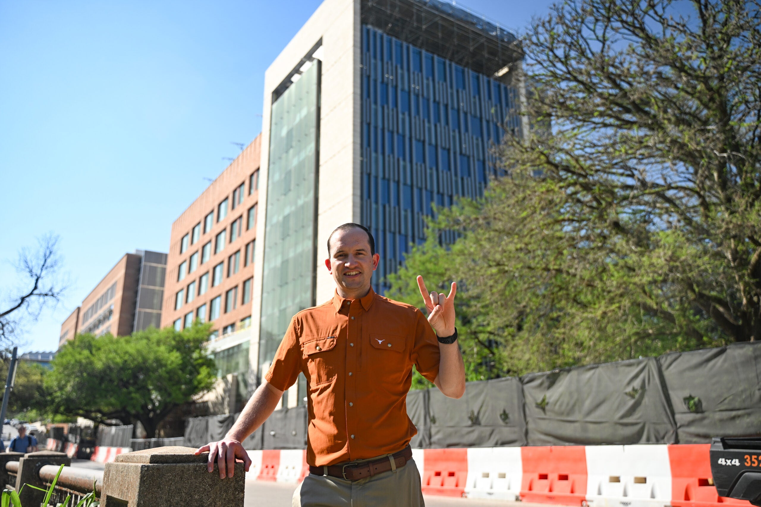 Texas Engineer Carlos CdeBaca gives a Hook 'Em hand symbol 