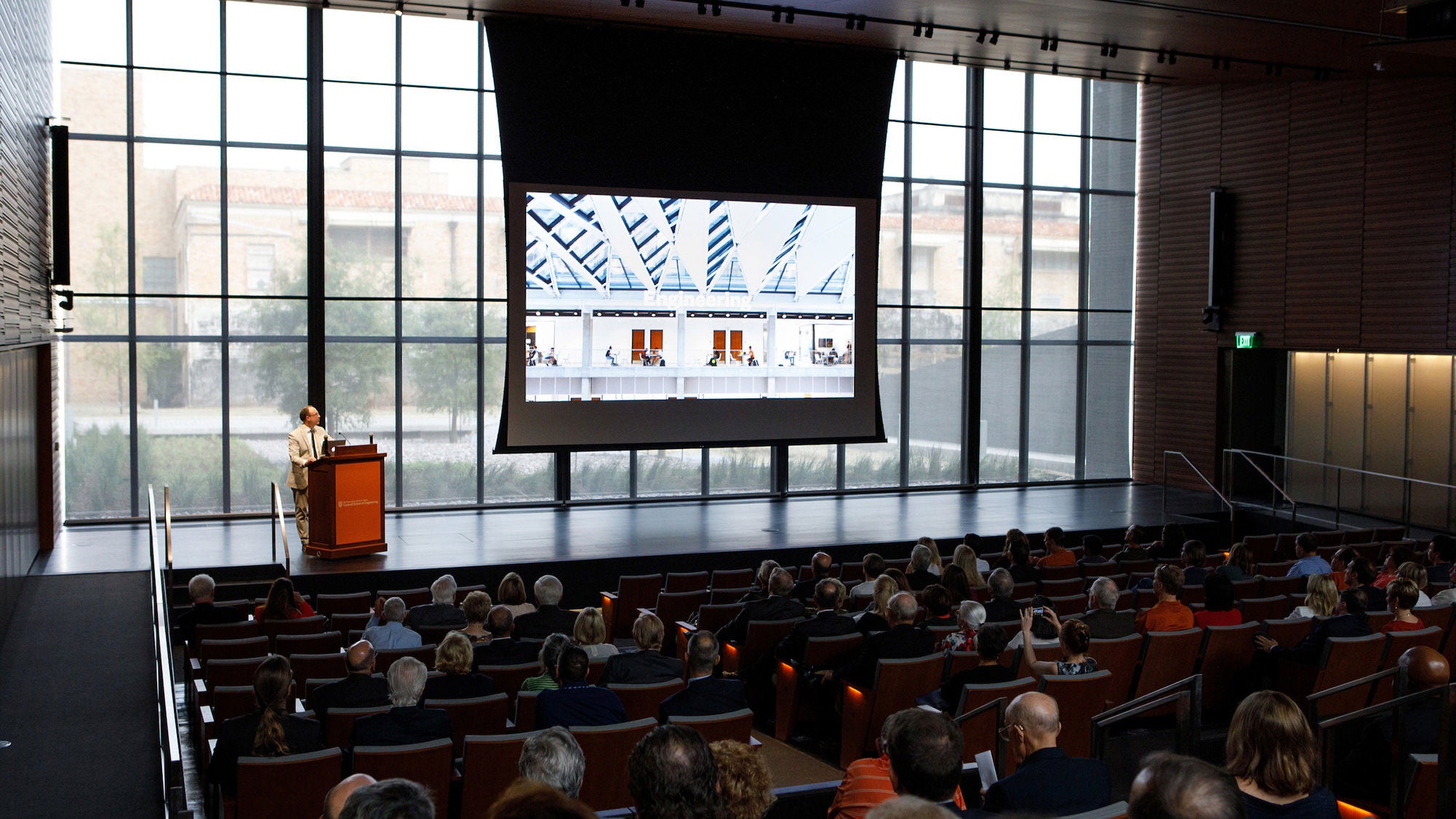 Man giving a presentation at the Mulva auditorium