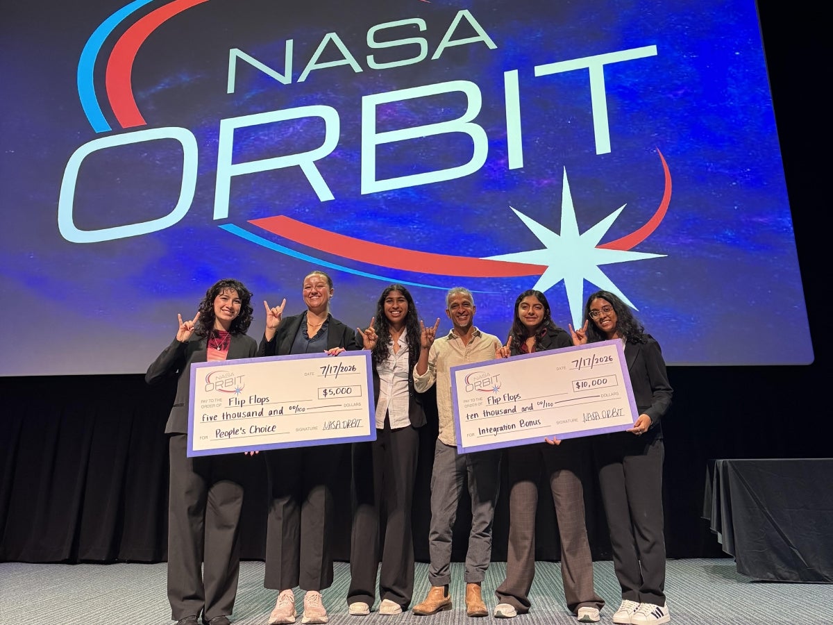A team of electrical and computer engineers at the NASA Orbit competition holding big checks.