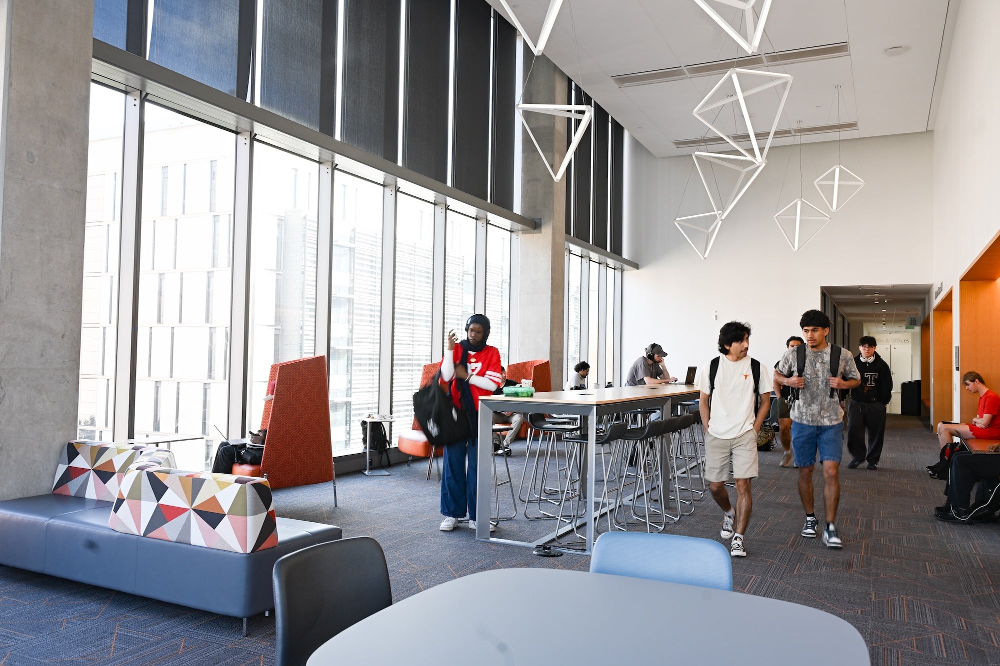 Students studying in the Hildebrand Lecture Lobby at UT Austin