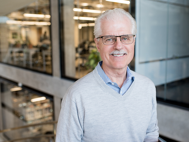 Portrait of John Ekerdt standing in the EER. 