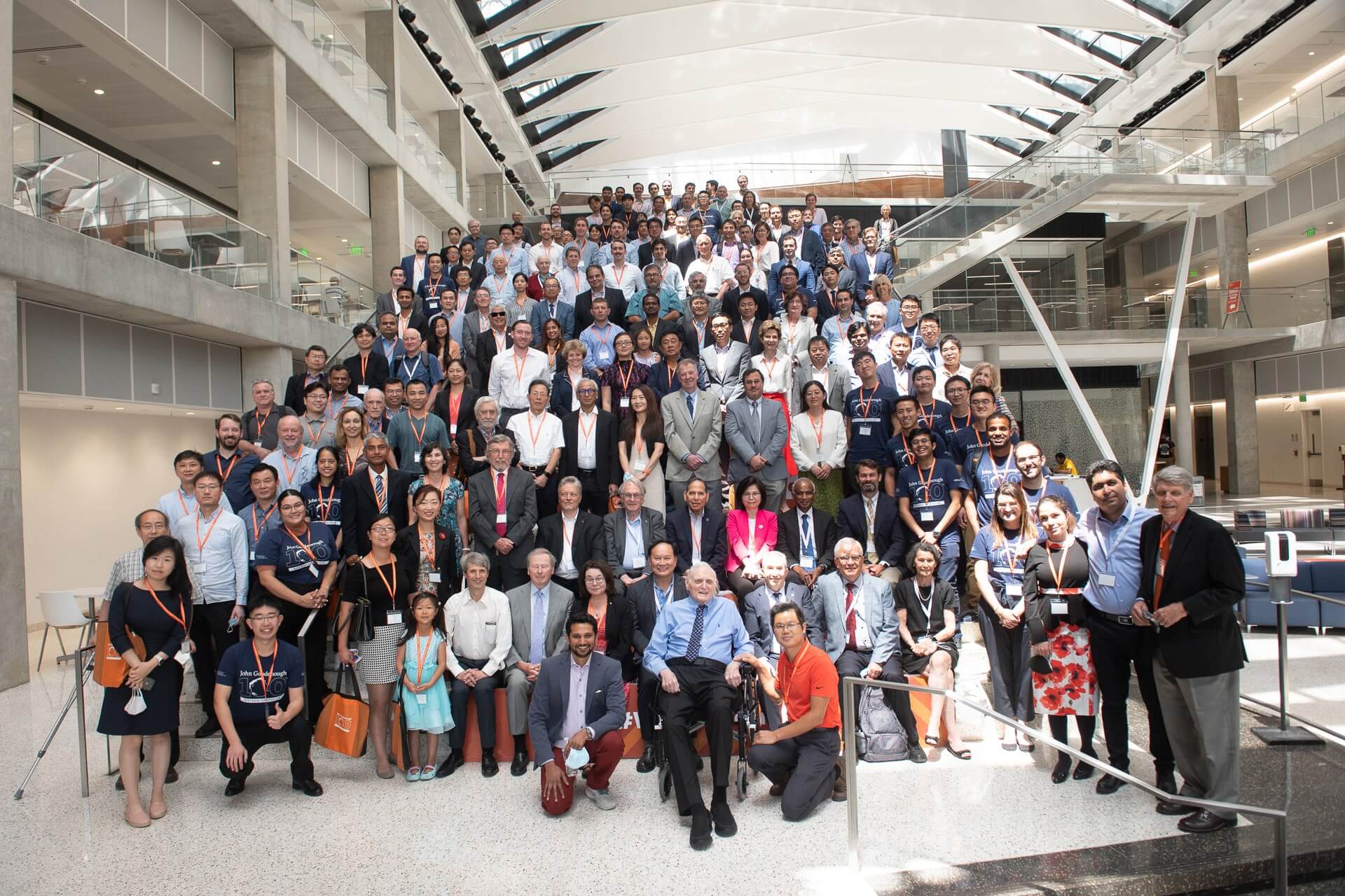 John B. Goodenough and large crowd of guests smiling for photo on EER staircase
